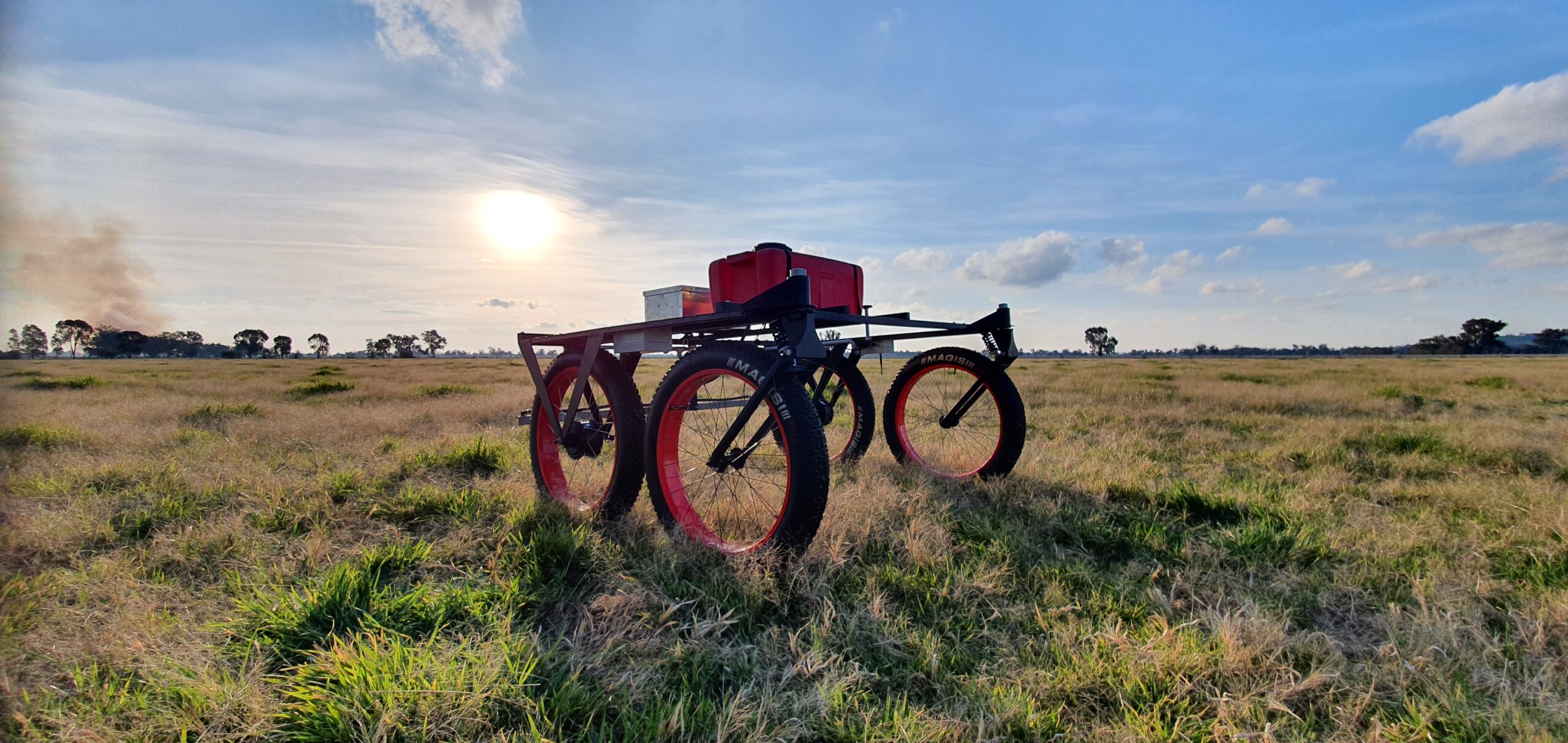 Autonomous weed spraying rover operating in a field.